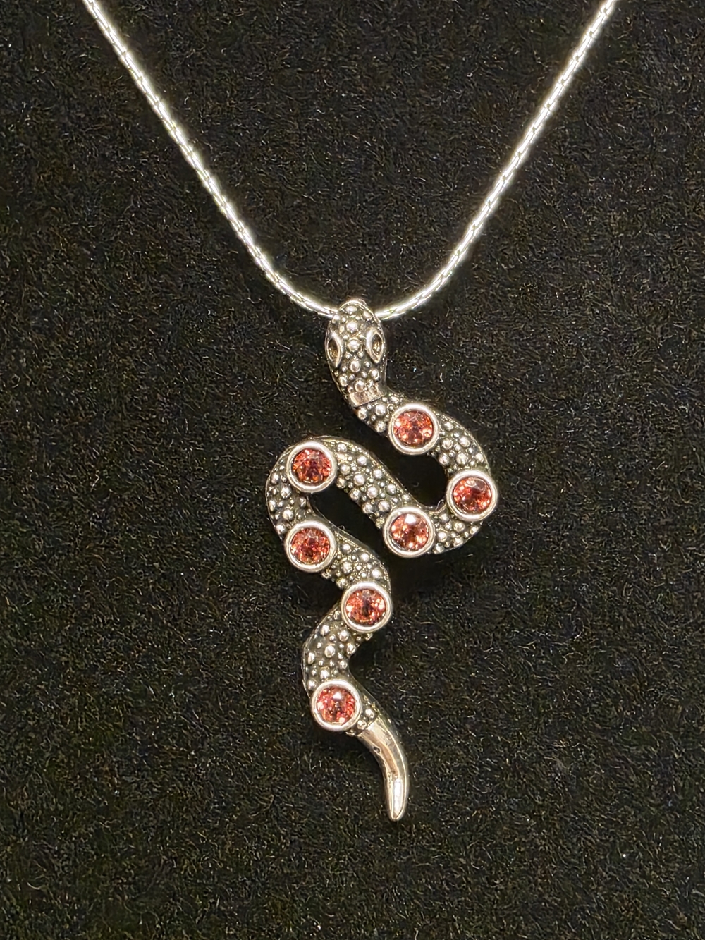 Silver Tone Snake Pendant Necklace with Garnet Accents